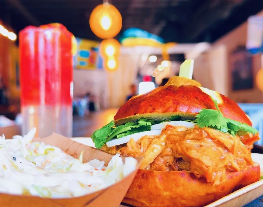 Sandwich and side served with a colorful cocktail at Royal James